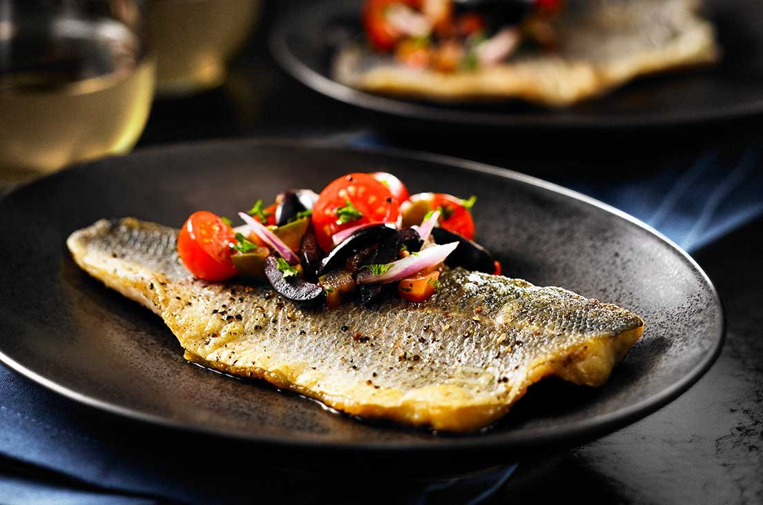 SeaBass Plate of grilled sea bass with tomato garnish